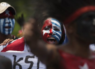 Papuan students, with their body and face painted with the colours of the banned Morning Star flag