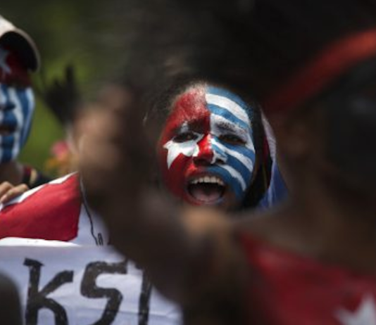 Papuan students, with their body and face painted with the colours of the banned Morning Star flag