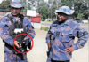 PNG police officers with a gun allegedly seized from an election candidate