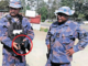 PNG police officers with a gun allegedly seized from an election candidate