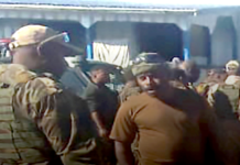 Papua New Guinean police question a PNGDF soldier stationed at Pares