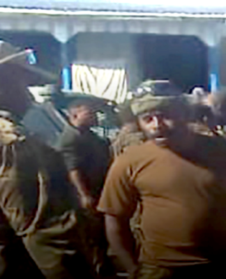 Papua New Guinean police question a PNGDF soldier stationed at Pares