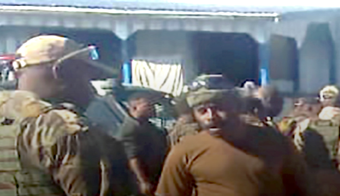 Papua New Guinean police question a PNGDF soldier stationed at Pares
