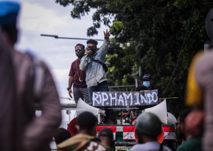 A Papuan protest in Jakarta with a banner reading 