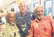 Madang's Sir Peter Barter (centre) passes on