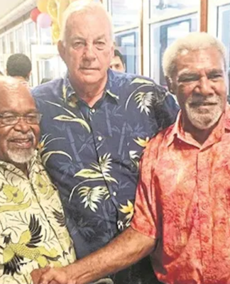 Madang's Sir Peter Barter (centre) passes on
