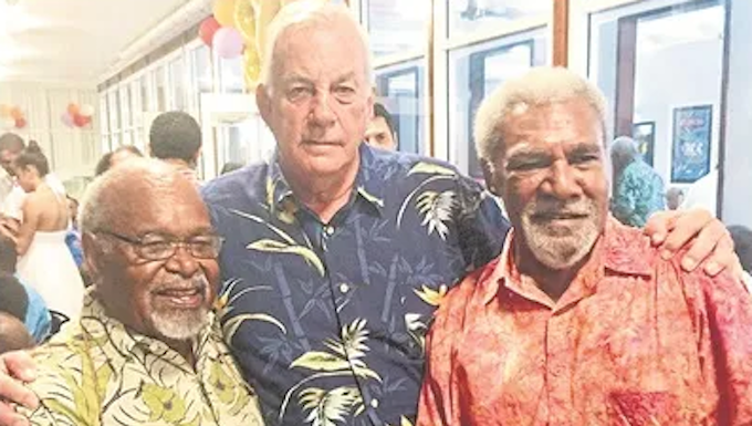 Madang's Sir Peter Barter (centre) passes on