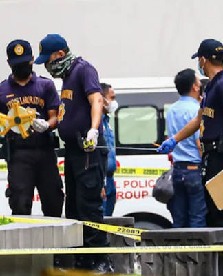 Three killed, including former mayor, in Manila university campus shooting Philippine police inspect the assassination crime scene at the Ateneo de Manila University