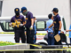 Philippine police inspect the assassination crime scene at the Ateneo de Manila University