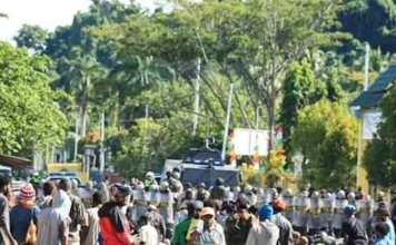 Papua People’s Petition protesters hold rallies against new Papuan provinces Papuan protesters sit on the ground in Meepago