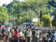 Papuan protesters sit on the ground in Meepago