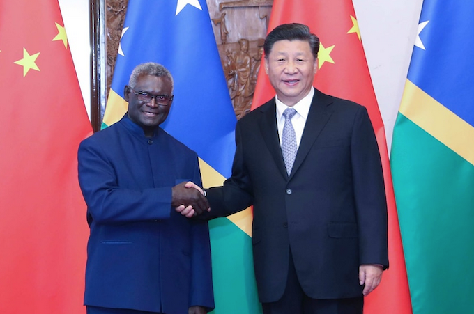 Solomon Islands' Prime Minister Manasseh Sogavare shaking hands with Chinese President Xi Jinping
