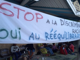 A "stop racial discrimination" banner at Magenta-Noumea Airport