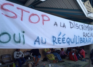A "stop racial discrimination" banner at Magenta-Noumea Airport