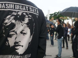 Munir's image pictured on an activist's T-shirt