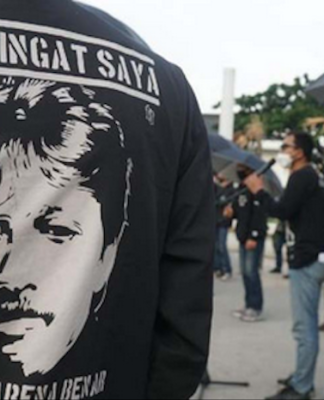 Munir's image pictured on an activist's T-shirt