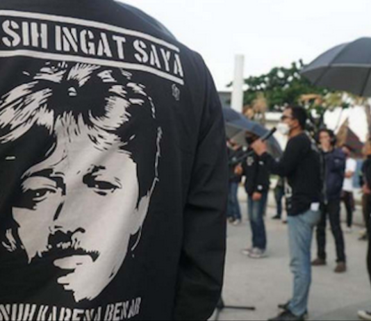 Munir's image pictured on an activist's T-shirt