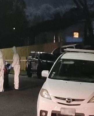 Police and forensic experts load the two bodies of children into a vehicle at a Clendon Park property