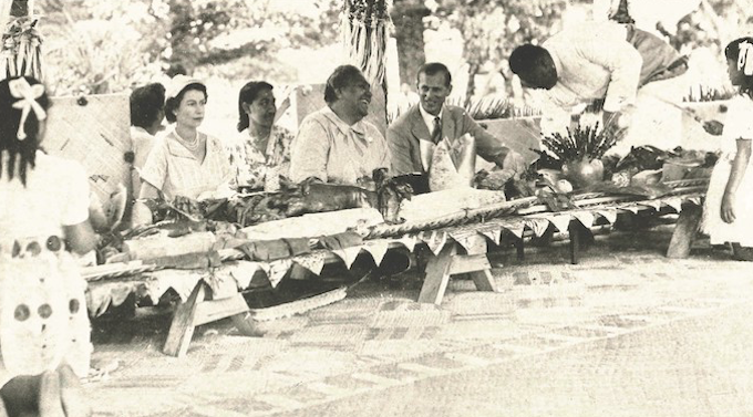 share a banquet with their Tongan hosts in 1953