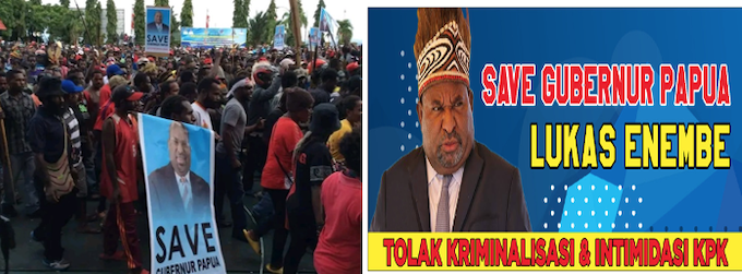 Papuan protesters hold banners in support of accused Governor Lukas Enembe