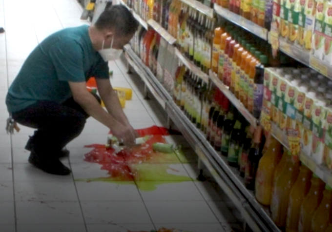 Shattered bottles in a Port Moresby store