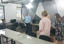 ABC news executives chat with a first-year student journalist and journalism coordinator Dr Shailendra Singh in the newly-refurbished USP journalism newsroom