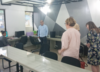 ABC news executives chat with a first-year student journalist and journalism coordinator Dr Shailendra Singh in the newly-refurbished USP journalism newsroom