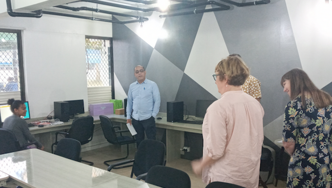 ABC news executives chat with a first-year student journalist and journalism coordinator Dr Shailendra Singh in the newly-refurbished USP journalism newsroom