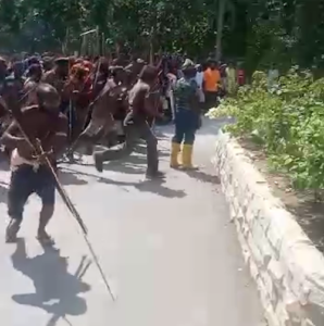 An angry group of Governor Lukas Enembe supporters performing a war dance