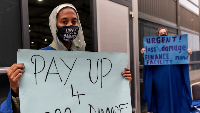 Protesters make a point to delegates at COP27 in Egypt