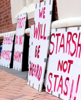 Anti-vax placards outside the High Court in Auckland