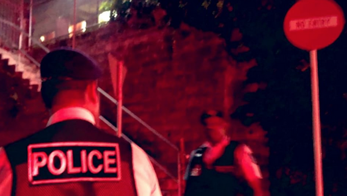 Fiji police officers standing outside the Criminal Investigations Department in Toorak where Sitiveni Rabuka was taken for questioning