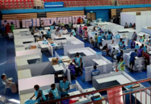 Manual counting underway at the National Counting Centre in the National Gymnasium in Suva