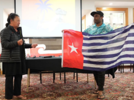 Hilda Halkyard-Harawira and Ronny Ato Buai Kareni with the Morning Star flag at the Nuclear Connections Across Oceania conference in Ōtepoti