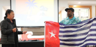 Hilda Halkyard-Harawira and Ronny Ato Buai Kareni with the Morning Star flag at the Nuclear Connections Across Oceania conference in Ōtepoti