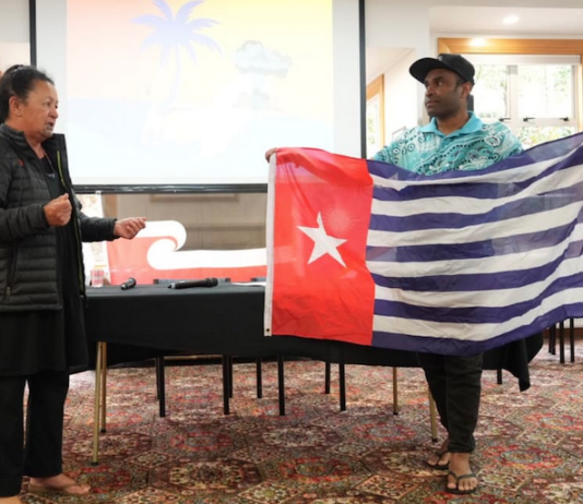 Hilda Halkyard-Harawira and Ronny Ato Buai Kareni with the Morning Star flag at the Nuclear Connections Across Oceania conference in Ōtepoti