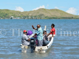 Nalati Ragolea (standing) with other Malake Villagers on their way to cast their vote at the Island