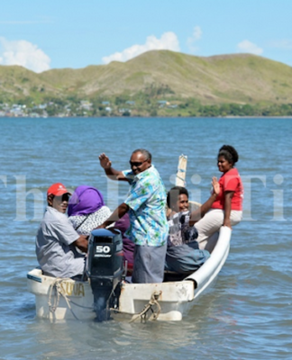 Nalati Ragolea (standing) with other Malake Villagers on their way to cast their vote at the Island