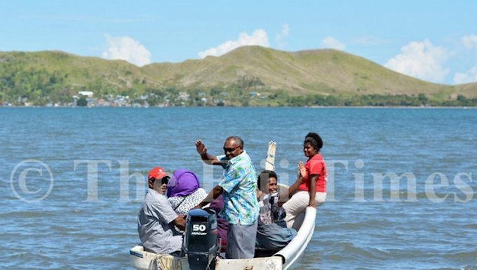 Nalati Ragolea (standing) with other Malake Villagers on their way to cast their vote at the Island