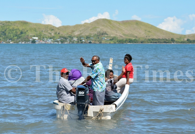 Nalati Ragolea (standing) with other Malake Villagers on their way to cast their vote at the Island