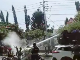 A video still showing Indonesian security forces using water cannon to suppress peaceful West Papuan protesters