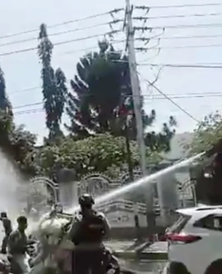 A video still showing Indonesian security forces using water cannon to suppress peaceful West Papuan protesters