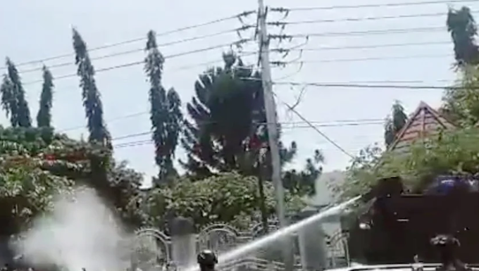 A video still showing Indonesian security forces using water cannon to suppress peaceful West Papuan protesters