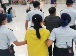 Republic of the Marshall Islands citizens Cary Yan and Gina Zhou being escorted by Thai police