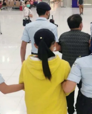 Republic of the Marshall Islands citizens Cary Yan and Gina Zhou being escorted by Thai police