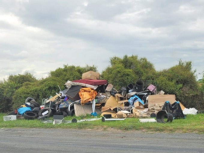 A photo taken by Turehou Māori Wardens Trust chairperson Mereana Peka last month showing piles of rubbish left by the side of the road in Ihumātao Rd, adjoining the Ōtuataua Stonefields Reserve