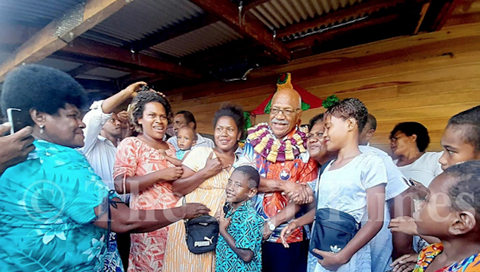 Fiji Prime Minister Sitiveni Rabuka with villagers of Wailevu