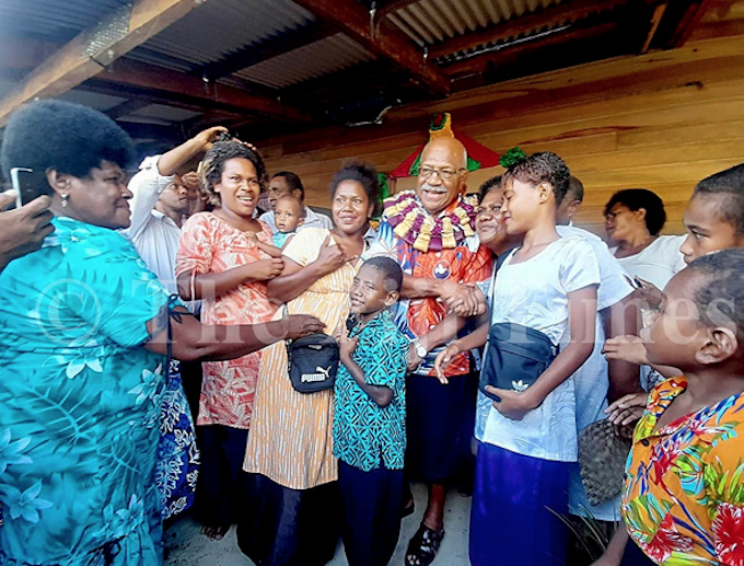 Fiji Prime Minister Sitiveni Rabuka with villagers of Wailevu