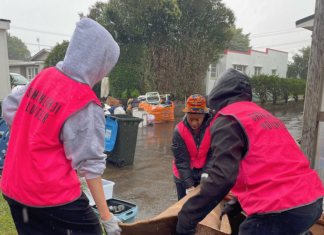 Volunteers help residents in Auckland's Mt Roskill to clear up after the flash floods hit the city last weekend