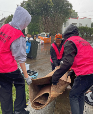 Volunteers help residents in Auckland's Mt Roskill to clear up after the flash floods hit the city last weekend